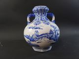 two blue and white vases sitting on a table