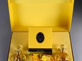 an image of a yellow box with three perfume bottles in it