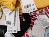 a pile of clothes and clothes tags on a table
