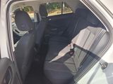 the back seat of a white car with a black seat belt