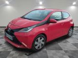 a red toyota ay parked on a checkered floor