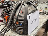 a lot of wires on a table with a sign on it