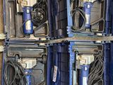 four blue boxes with tools in them sitting on the floor