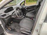 the interior of a car with the door open and the driver ' s seat down