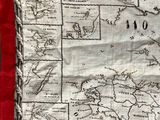 a close up of a map of the world on a red cloth