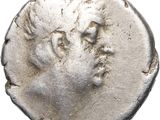 a silver coin with a head of a man on it