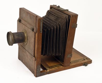 an old wooden camera that is sitting on a table