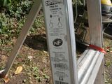 a ladder that is sitting on the ground in the yard