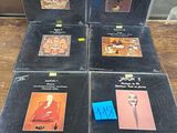 six lp ' s in a box on a table in a store