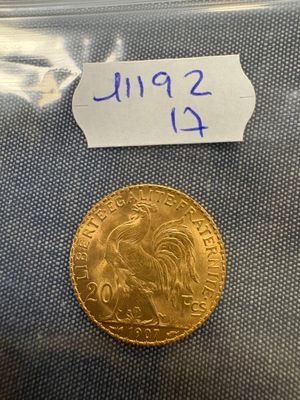 a close up of a gold coin with a price tag on it