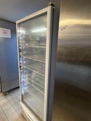 a refrigerator that is sitting in a kitchen next to a refrigerator
