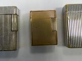 three different types of lighters are lined up on a white surface