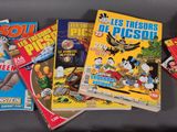 a lot of comic books on a black surface