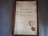 framed photograph of a medal and a ribbon on a wall