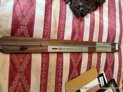 a ruler on a bed with a red and white striped blanket