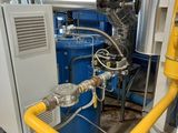 a yellow pipe and a blue tank in a room