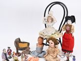 a lot of dolls and figurines sitting on a table