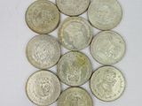 six different types of silver coins on a white surface
