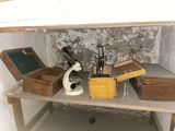 a small table with a microscope and other items on it