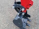 a close up of a red and black machine on the ground