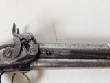 an old gun that is on display on a wall