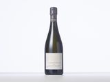 a bottle of wine sitting on top of a white table