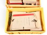 two yellow boxes filled with books and papers sitting on top of each other
