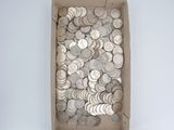 a box full of silver coins sitting on a table