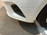 a close up of a car ' s front bumper with a hole in it