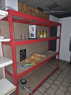 a red shelf that has some items on top of it