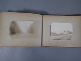 an old photo of a book opened to show a picture of a road