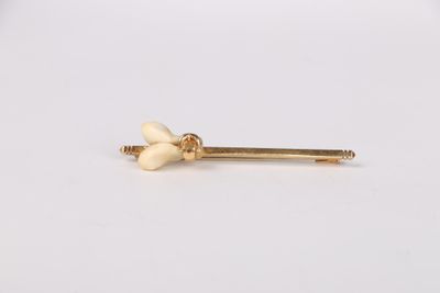 a pair of gold nose studs with white pearls on them