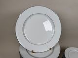 several white plates stacked on top of each other on a table