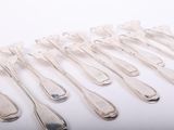 a lot of silver spoons and forks on a white surface