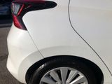 a close up of a white car parked in a parking lot