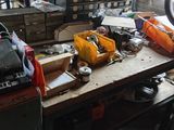 a workbench with a lot of assorted items on it