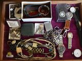 a wooden box filled with assorted items on a table