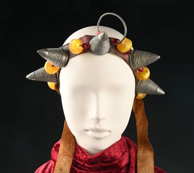 a white mannequin headpiece with metal spikes on it