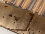 a close up of a metal object with writing on it