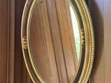 a mirror hanging on the wall in the corner of a room