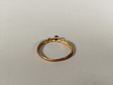 a close up of a gold ring on a white surface