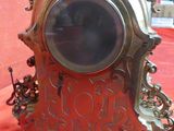 a clock that is sitting on a red cloth