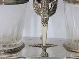 a silver plate with two glasses and a candle holder