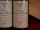 two bottles of wine sitting next to each other on a table
