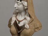 statue of a woman with a veil on her head on a wooden table