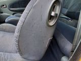 a yellow car with a black seat in the back of it