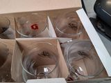 six empty glasses in a box on a table