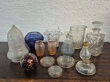 de nombreux vases en verre de toutes sortes posés sur une table en bois