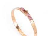 a gold ring with pink sapphire stones