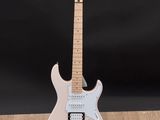 a white electric guitar sitting on top of a wooden floor